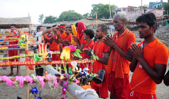 Hindu Devotees known as Kanwariya offer prayer before