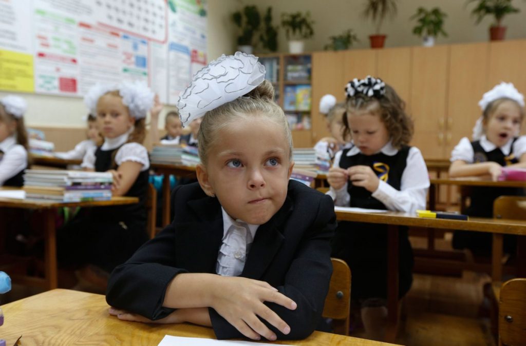 Students attend their first lesson of the day in a school in the southern coastal town of Mariupol
