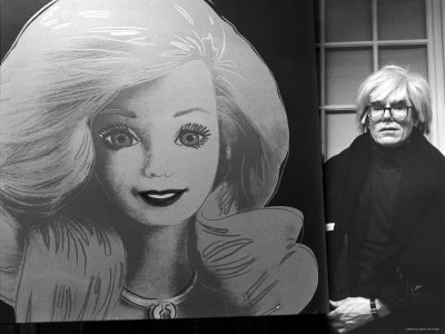 andy-warhol-displaying-his-portrait-of-a-barbie-doll