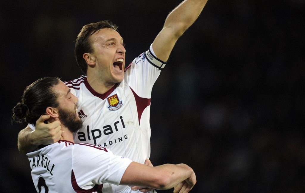 West Ham United's captain Mark Noble celebrates scoring a goal with teammate Andy Carroll during their English Premier League soccer match against Cardiff City at Cardiff City Stadium