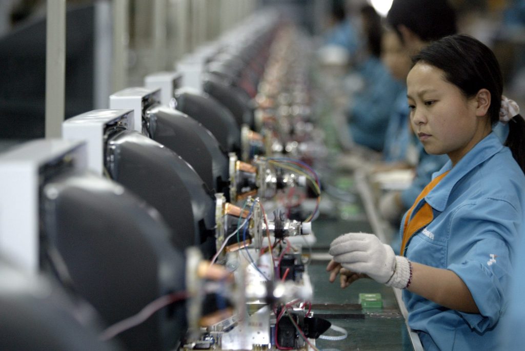 Chinese workers assemble televisions at a factory of leading electronics producer Hisense
