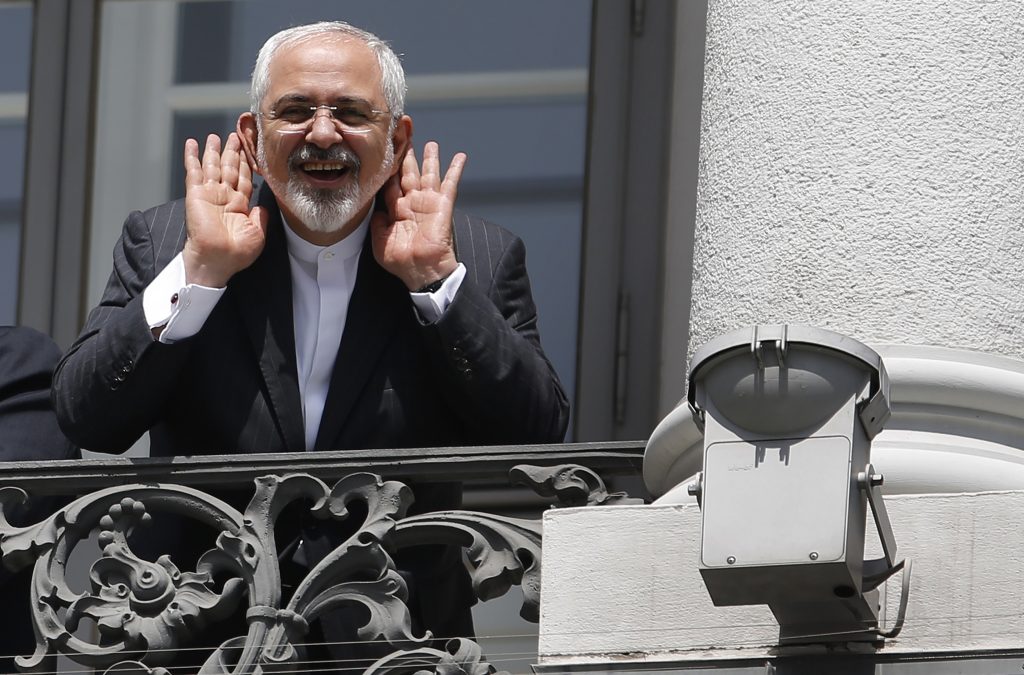 Iranian Foreign Minister Mohammad Javad Zarif reacts as he stands at a balcony of the Palais Coburg hotel where the Iran nuclear talks are being held in Vienna