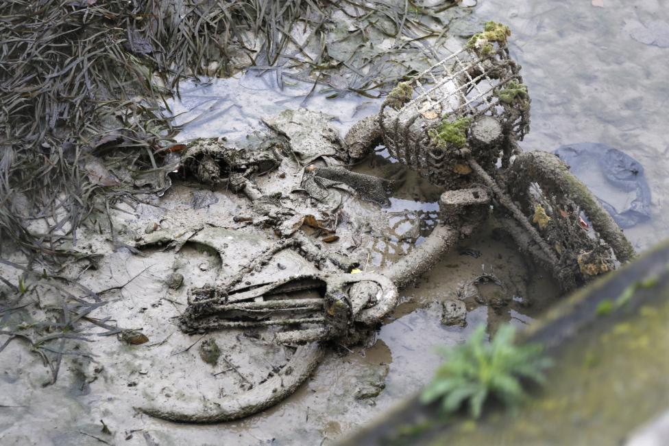 An abandoned mud covered Velib self-service public bicycle appears after the draining of the Canal Saint-Martin in Paris