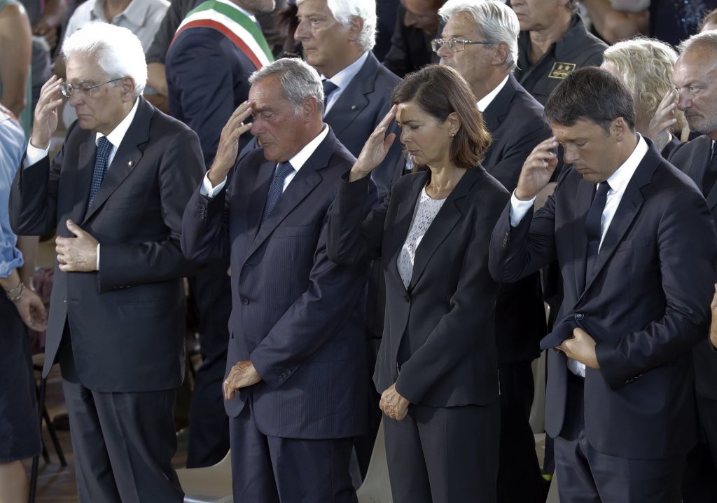 From left, Italian President Sergio Mattarella, Italian Senate President Pietro Grasso, Italian Lower Chamber President Laura Boldrini and Italian Premier Matteo Renzi attend the funeral service of some of the earthquake victims in Ascoli Piceno, Italy, Saturday, Aug. 27, 2016. (AP Photo/Andrew Medichini)