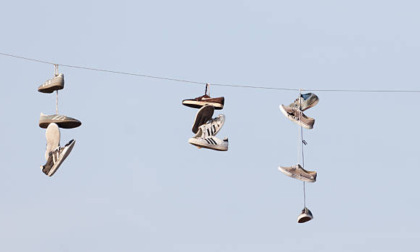 Le vecchie scarpe appese ai cavi della Teb di Bergamo: non per forza simbolo di spaccio